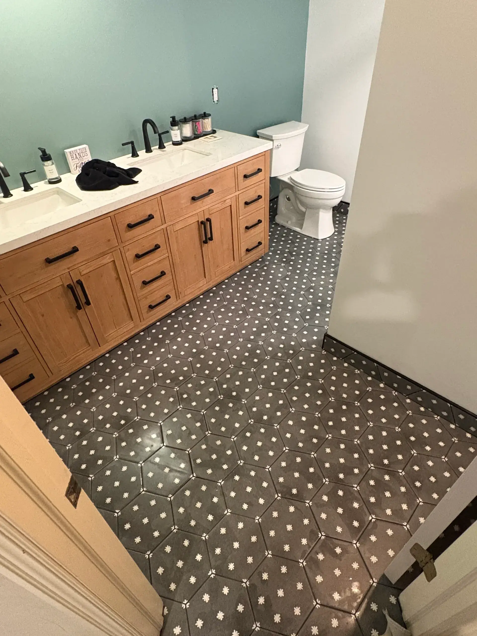 Modern bathroom with hexagonal patterned floor tiles.